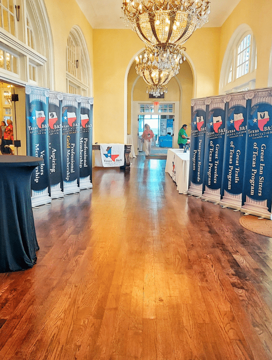 image of hotel ballroom recpetion area with Texas Bed and Breakfast association banners.